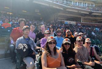 A group of people sitting in a baseball stadium